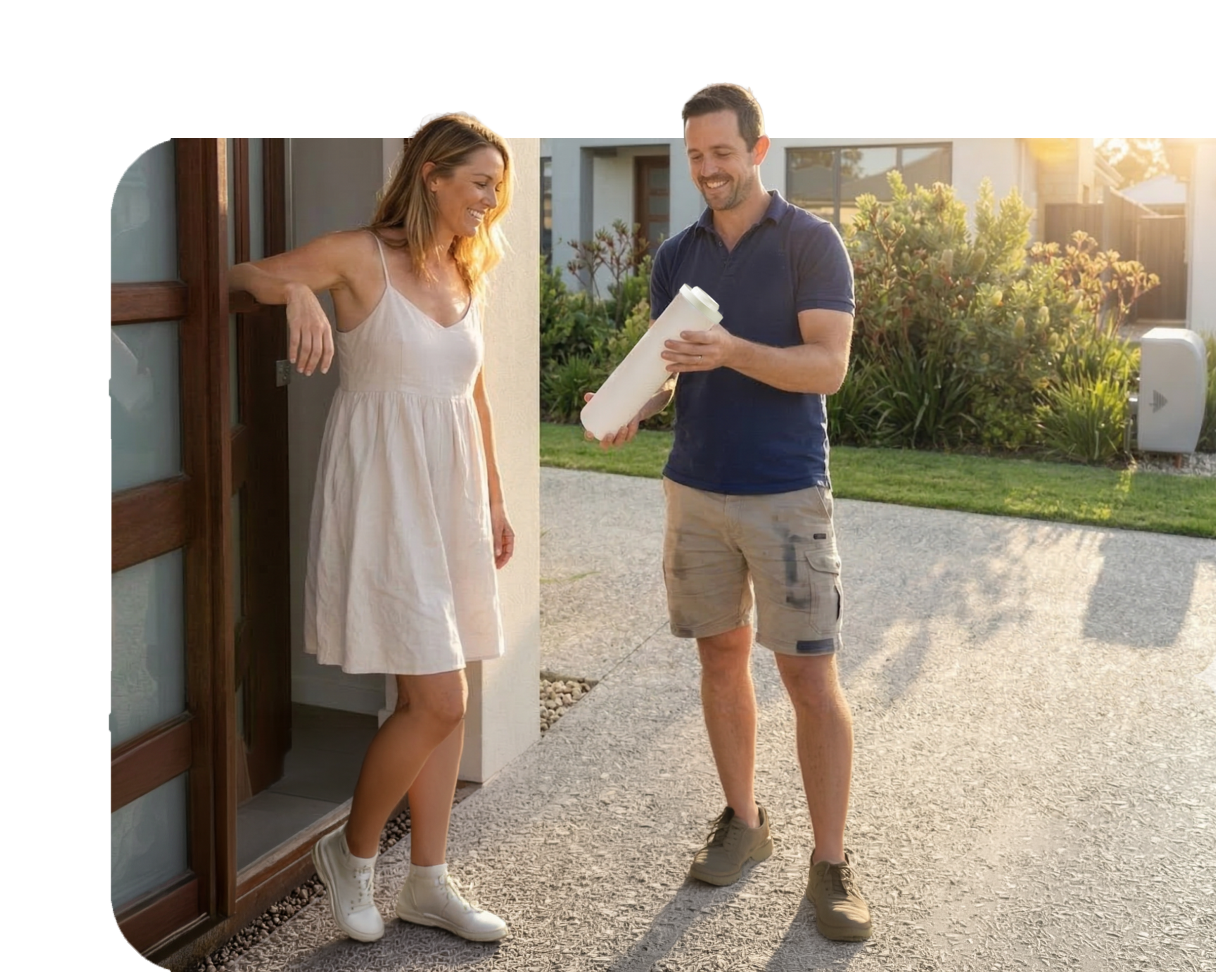 Service technician holding a clean filter while speaking to a woman in a doorway.